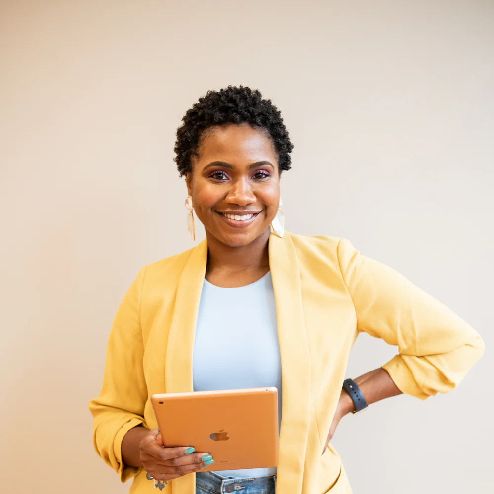 A smiling small-business owner holding a tablet
